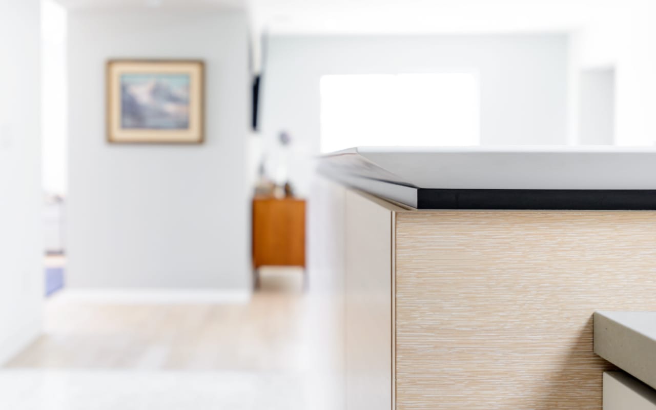 Close up of a black countertop on a kitchen island.