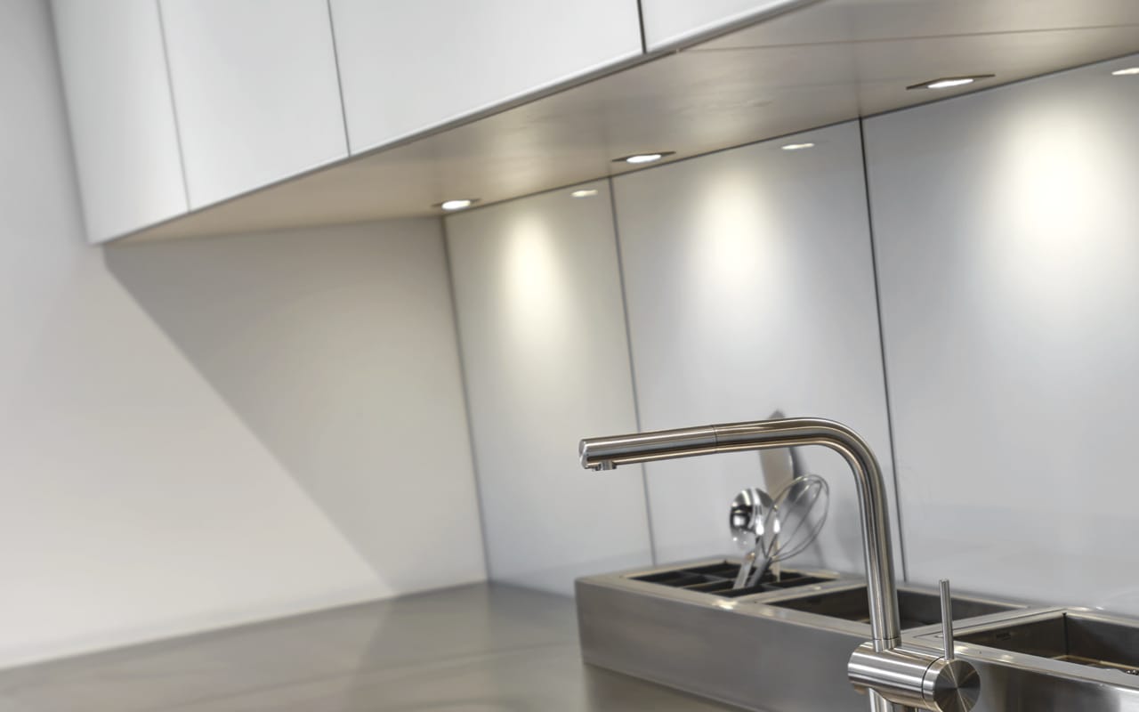 Underneath shot of white cabinet with under-cabinet pot lighting.